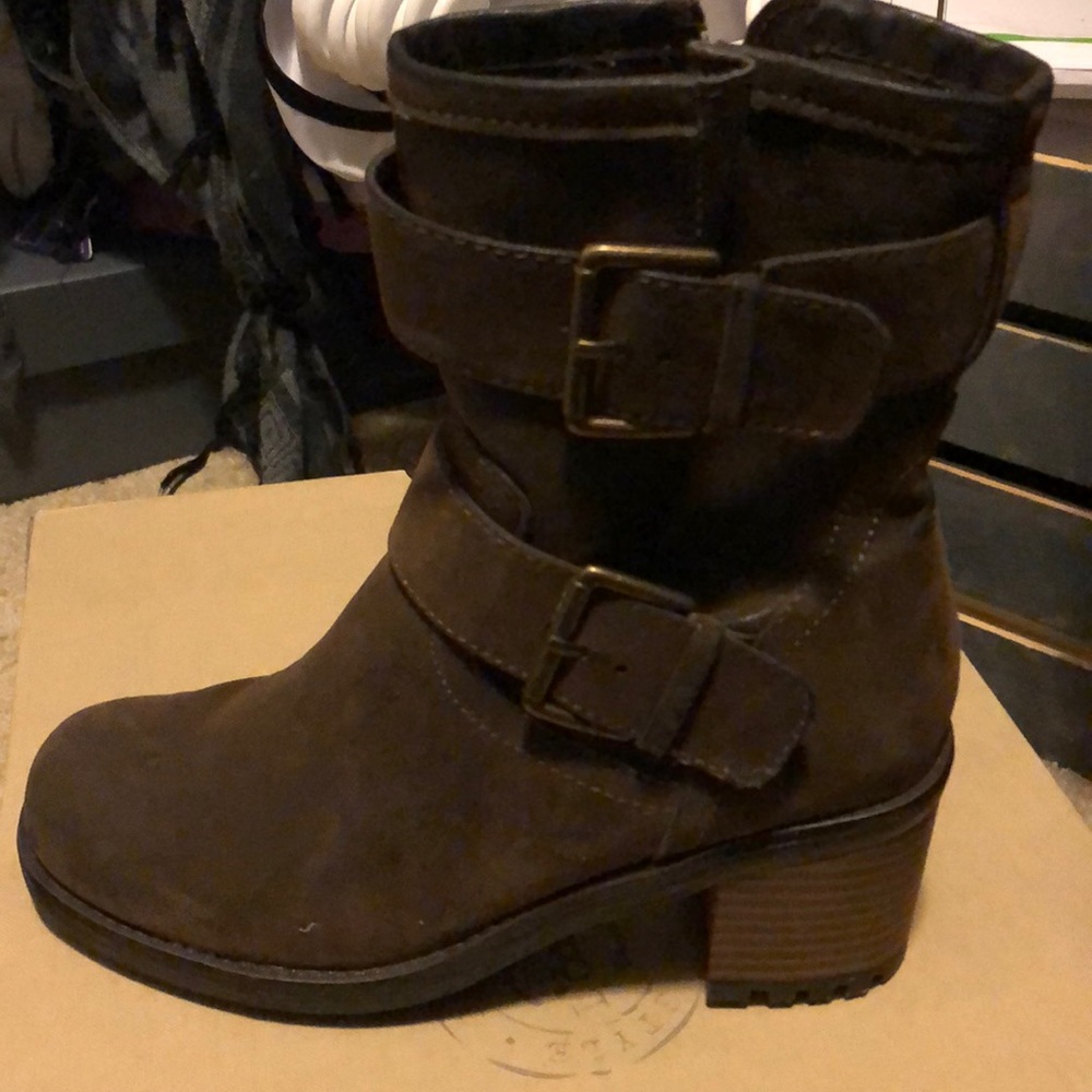 Heeled boots that are brown with a cute buckle.